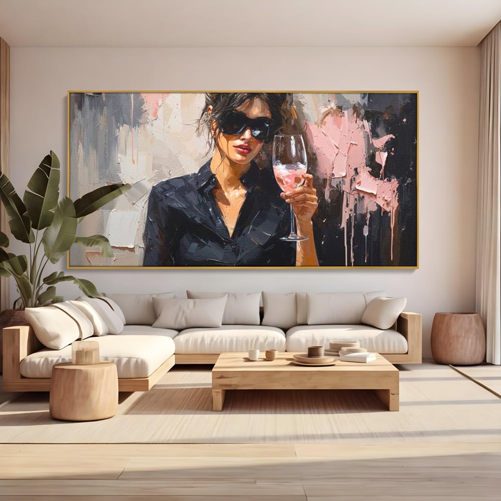 Tablou canvas cu tablou canvas cu femeie si pahar de vin, in rama de aluminiu auriu, pe perete intr-un living